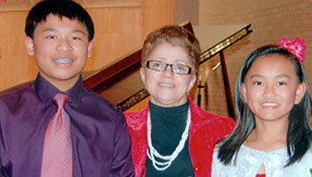 Picture of Irina with 2 of her students at a Christmas Recital